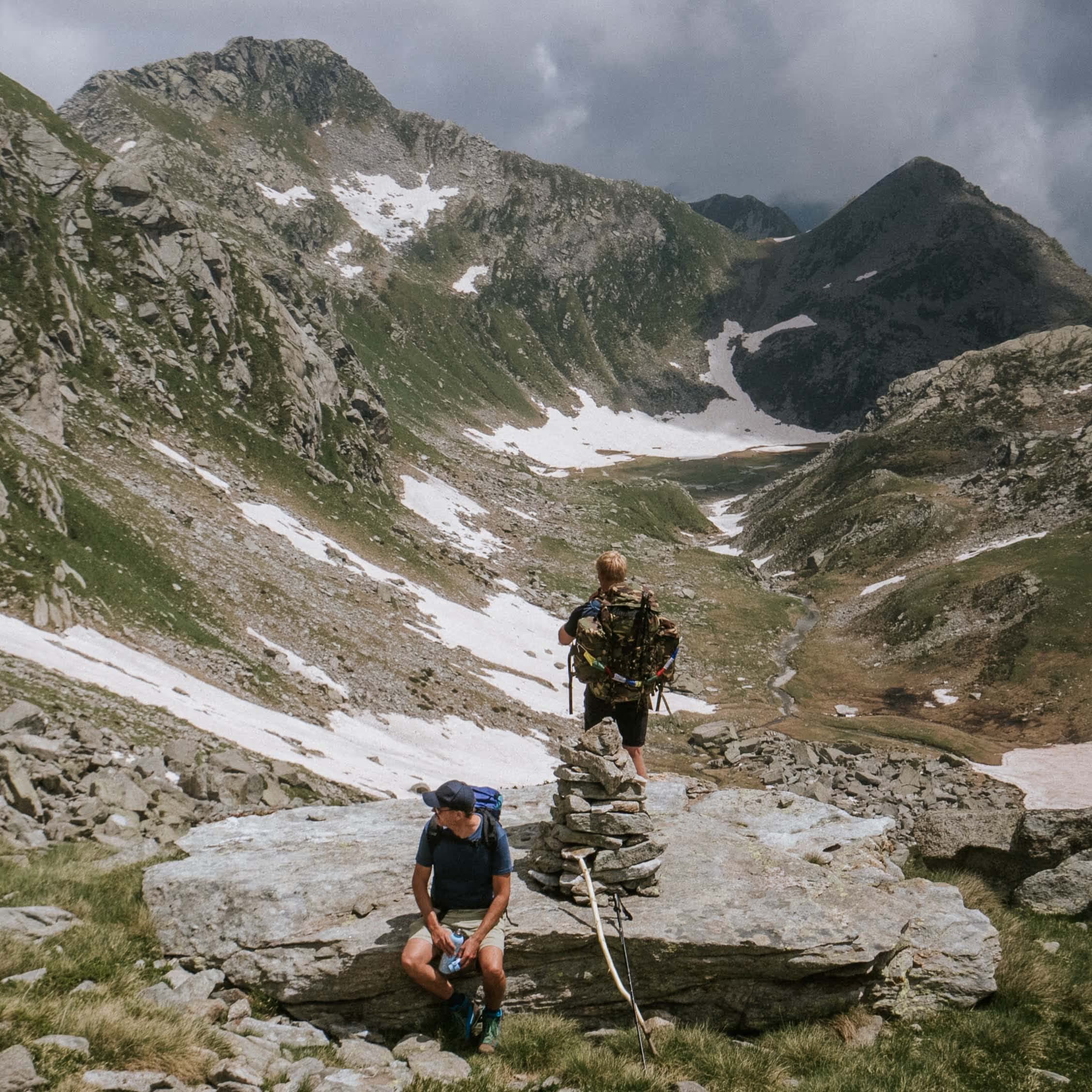 A group of men walking a wild alpine valley