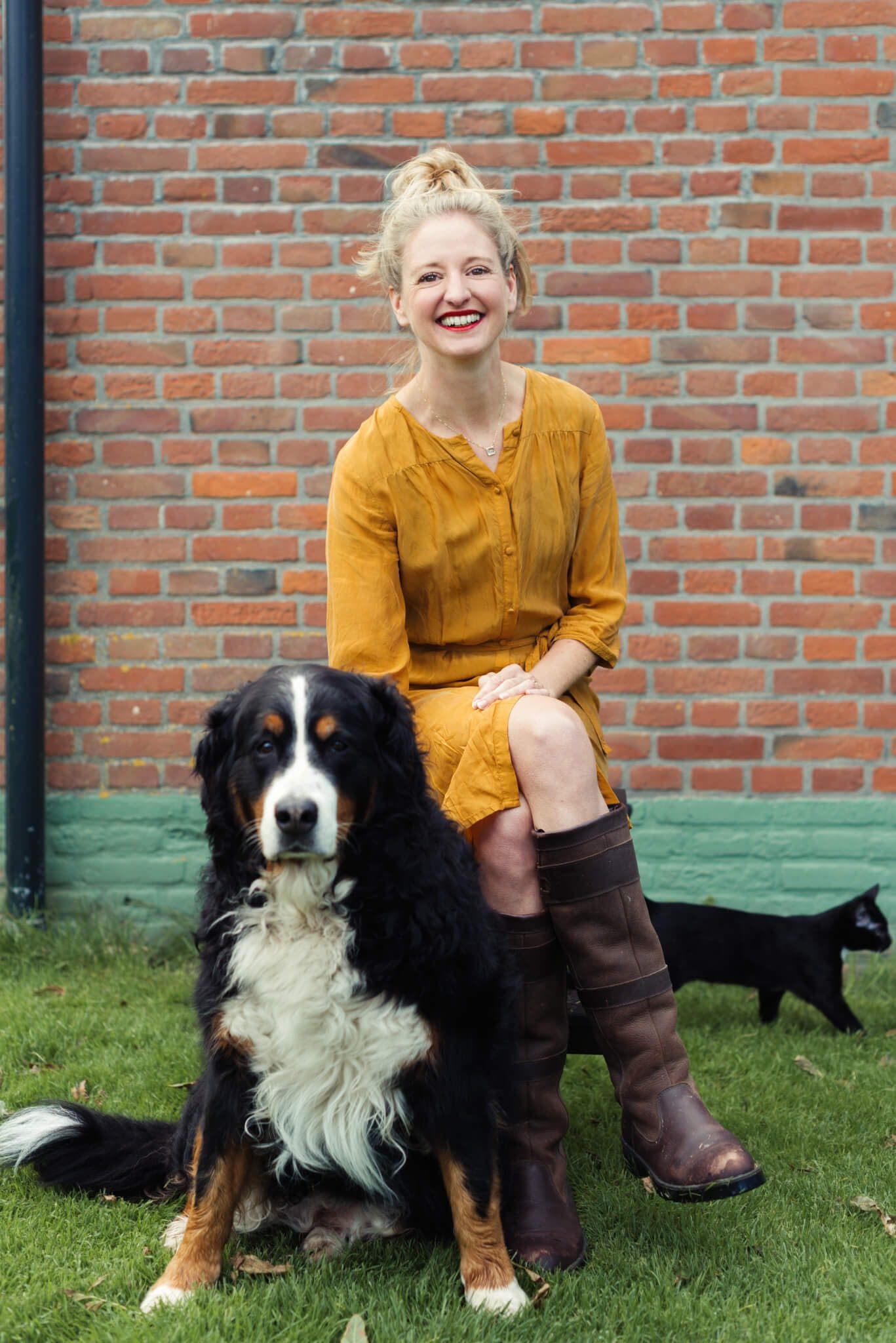 Kim and the dog by the farmhouse wall