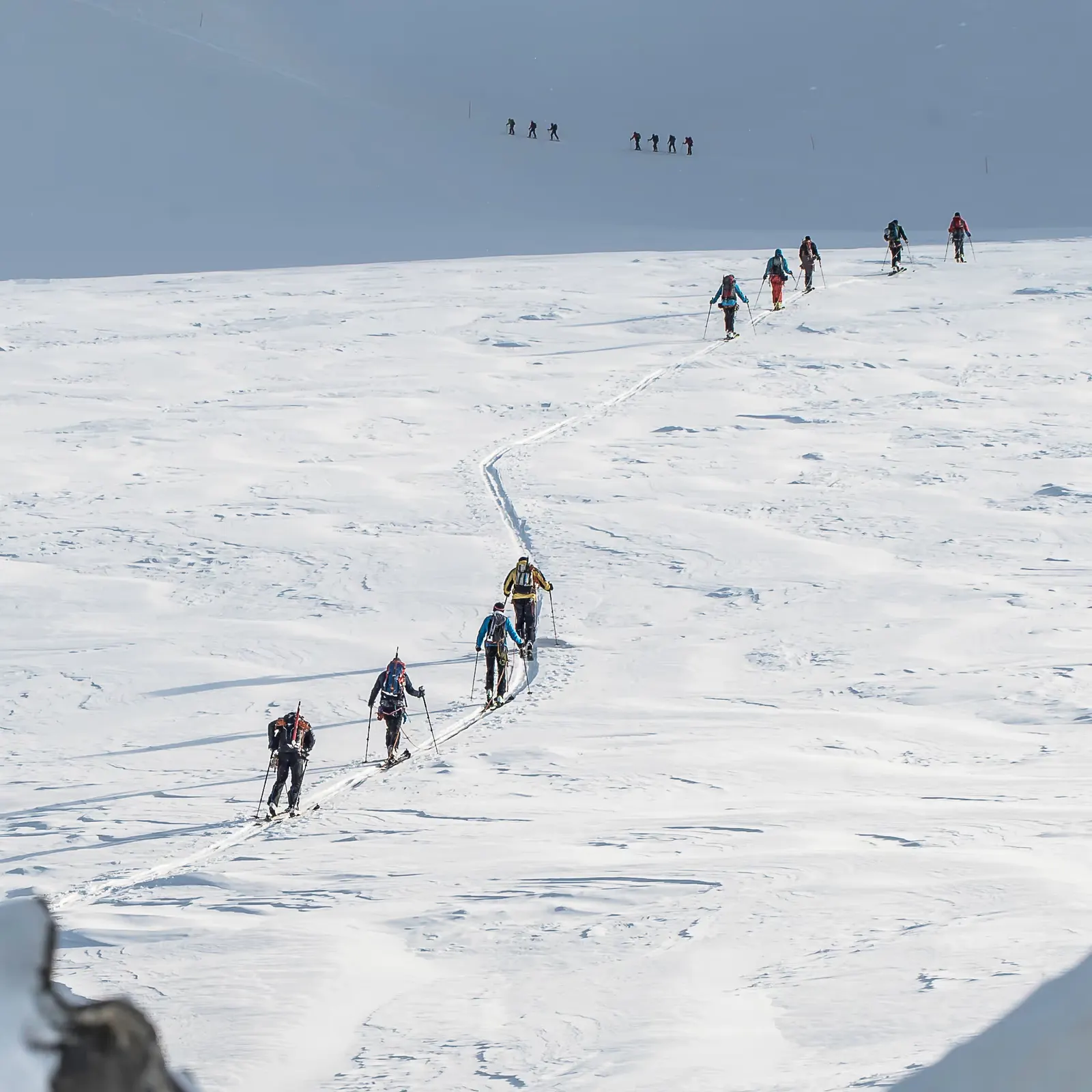 Ski tourers ascending a snow slope in the Alps