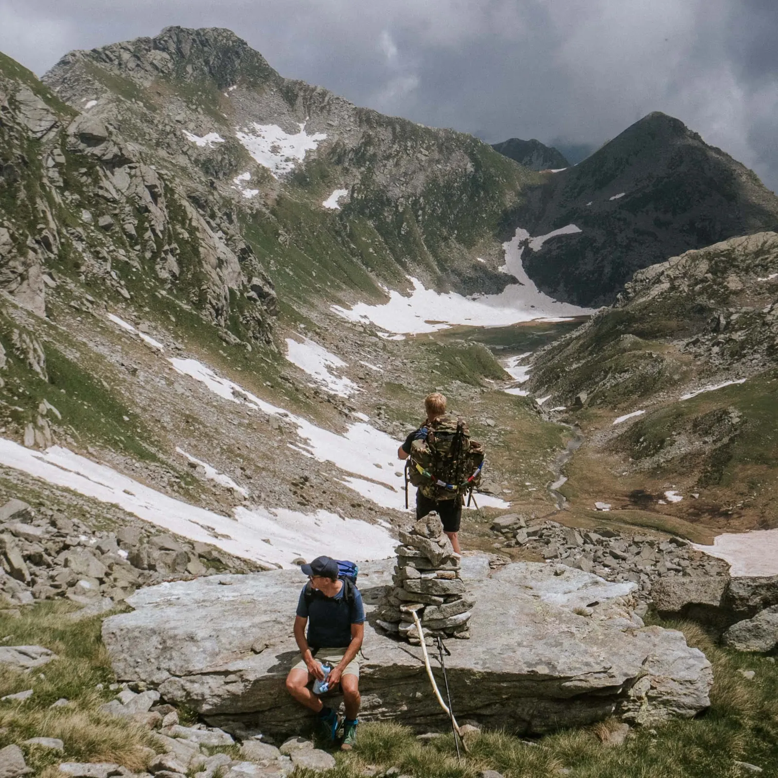 A group of men walking a wild alpine valley