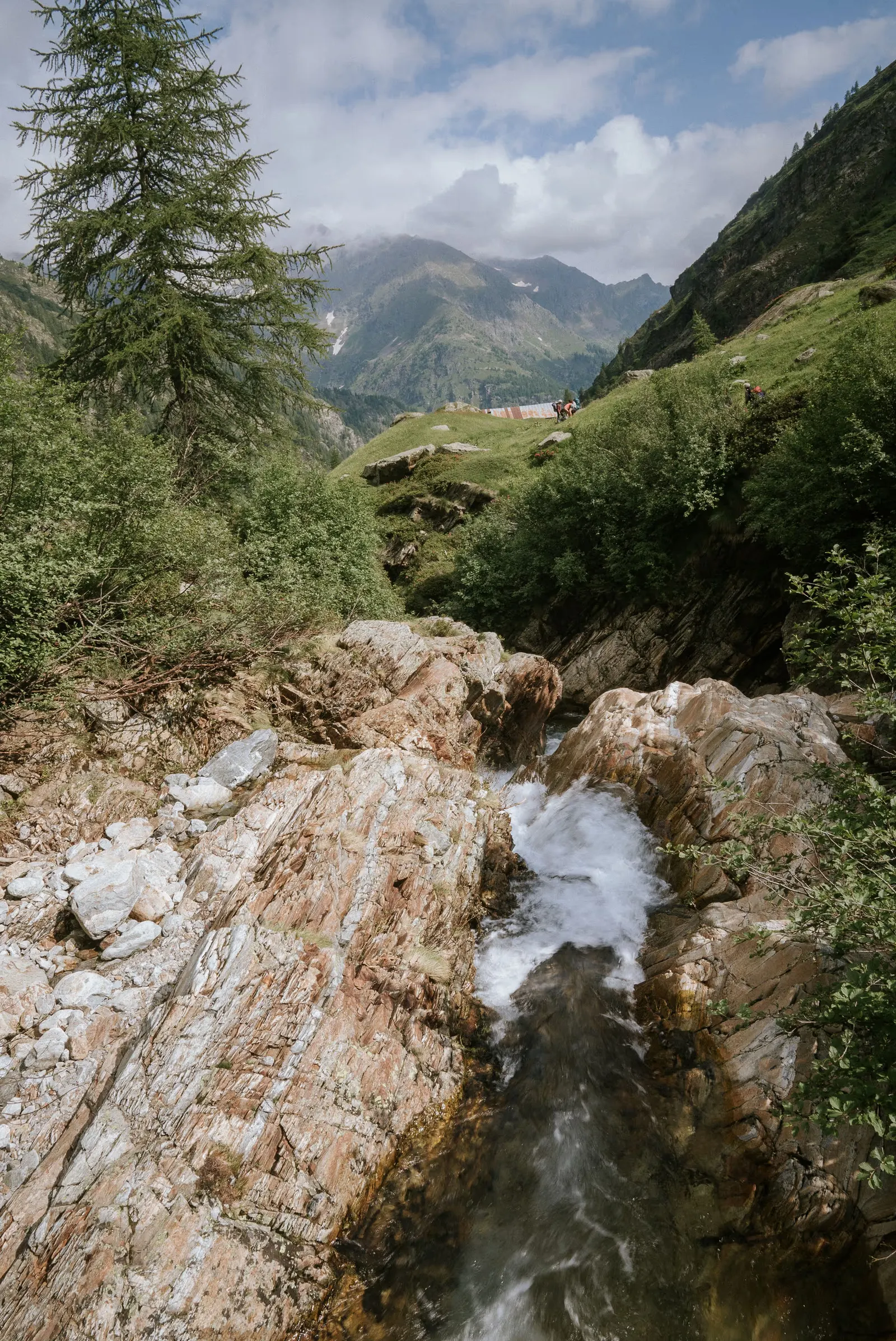 A walker standing still in a wide alpine landscape