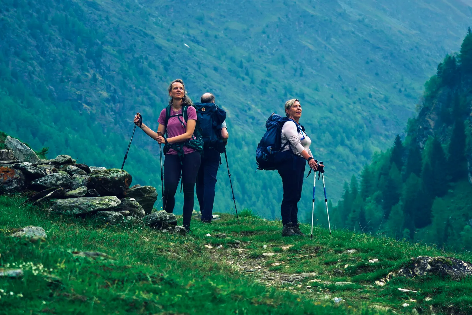 Walkers climbing towards a high alpine pass